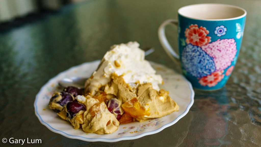 Breakfast of champions. Pavlova with brown sugar cream, cherries, and mango. Served with coffee. Gary Lum.