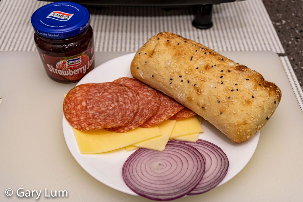 Turkish bread roll, salami, mozzarella, Colby, red onion, and jam.