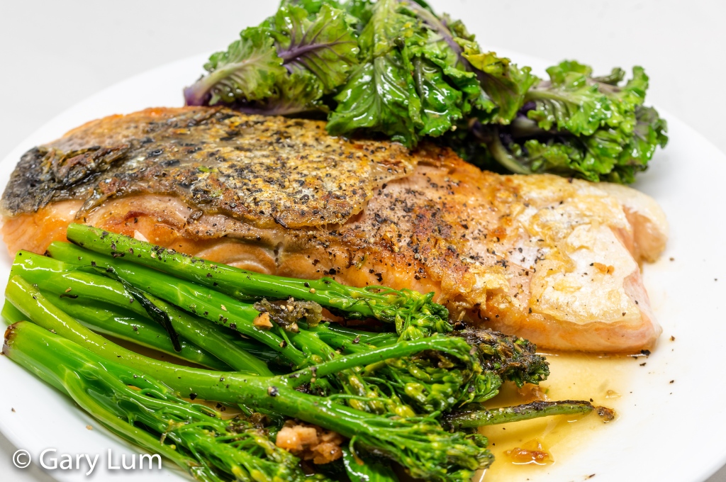 Pan-fried gnarly skinned salmon with steamed broccolini and kale sprouts