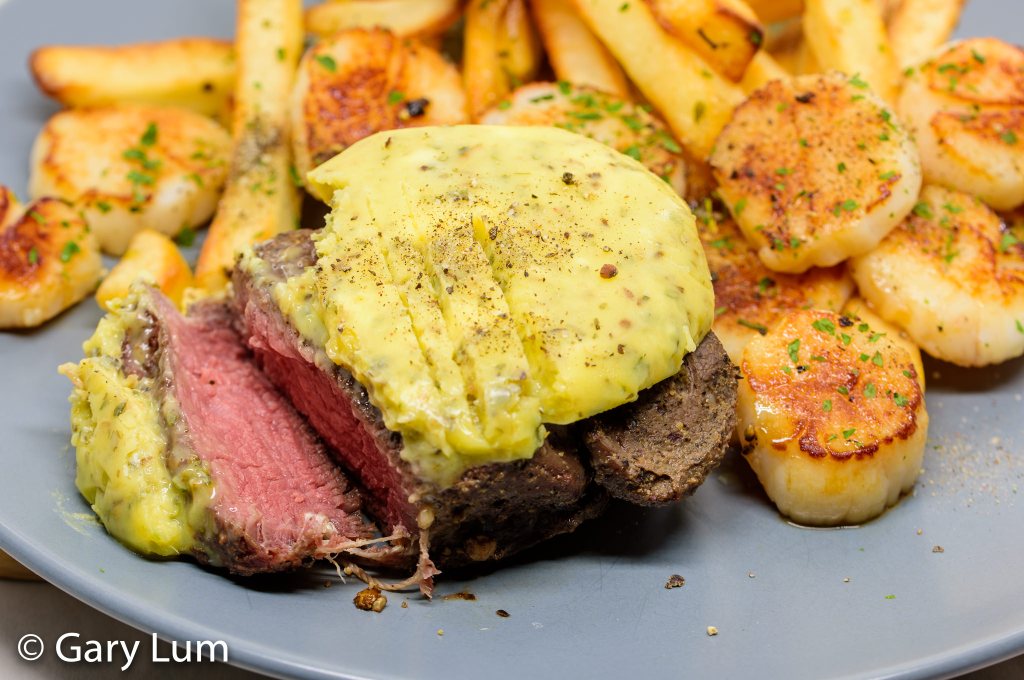 Garlic butter steak and chips tossed in garlic butter with scallops